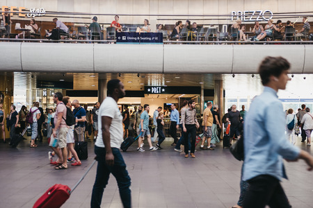 People walking past Pret A Manger cafe inside King's Cross station, one of the largest railway stations in London and a significant transport hub.のeditorial素材