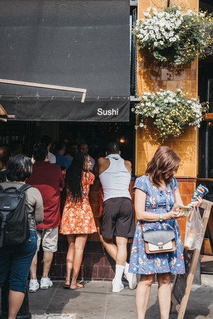 London, UK - July 21, 2018: People standing outside UKAI gastropub in Portobello Road Market, one of the most popular tourist sites in London, UK.のeditorial素材