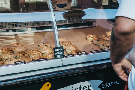 London, UK - September 17, 2018: Fresh pies on sale at Pieminster market stand in Borough Market,...