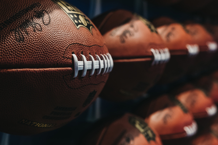 NEW YORK, USA - MAY 28, 2018: Rows of american football balls in NFL Experience in Times Square, New York, a first-of-its-kind live action attraction, combining interactive games and 4D theatre.のeditorial素材