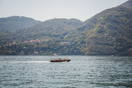 Lake Como, Italy - July 6, 2017: Speed boat on Lake Como, on a bright summer day.  Lake Como is the third-largest lake in Italy after lakes Garda and Maggiore.のeditorial素材