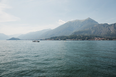 Unidentified boat on Lake Como, Italy, on a bright summer day.の写真素材