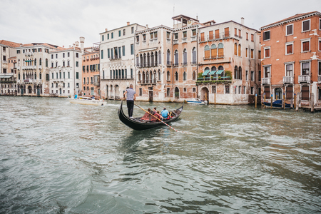 Venice, Italy - July 02, 2017: Gondola on Grand Canal in Venice with colourful houses on the background. Boats are the main mode of transport in the city.のeditorial素材