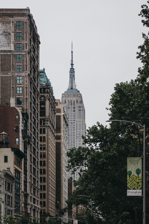 New York, USA - May 28, 2018: View of the top of of the Empire State Building from Fifth Avenue. Empire State Building is a famous 102-story Art Deco skyscraper in Midtown Manhattan, New York City.のeditorial素材