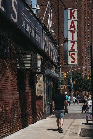 New York, USA - May 29, 2018: Man walks on Ludlow Street past Katz's Deli in New York, iconic kosher-style delicatessen that has been open since 1888.のeditorial素材