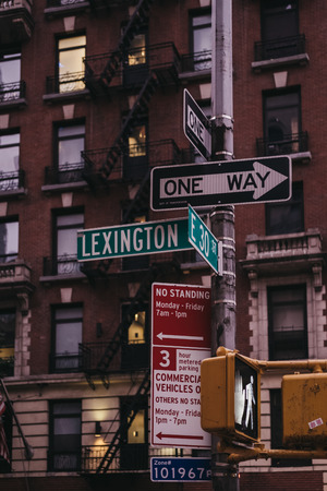 New York, USA - May 29, 2018: Street name and road signs on a lamp post on the corner of Lexington Avenue and 30th East Street in Manhattan, New York, USA. New York is one of the most visited cities iのeditorial素材