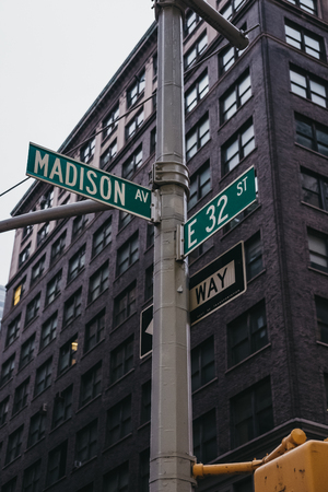 Street name and road signs on a lamp post on the corner of Lexington Avenue and 30th East Street in Manhattan, New York, USA.のeditorial素材