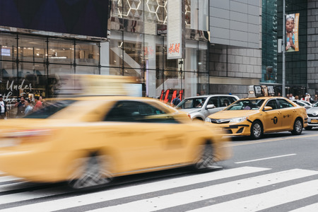 New York, USA - May 28, 2018: Yellow taxi on the street in New York, motion blurred. Yellow taxis are recognised worldwide as the icons of the city.のeditorial素材