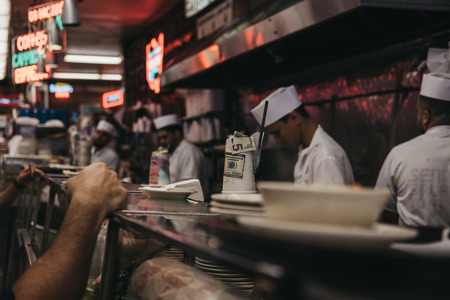 New York, USA - May 29, 2018: Customers waiting for food at the counter in Katz's Deli in New York, iconic kosher-style delicatessen that has been open since 1888.のeditorial素材