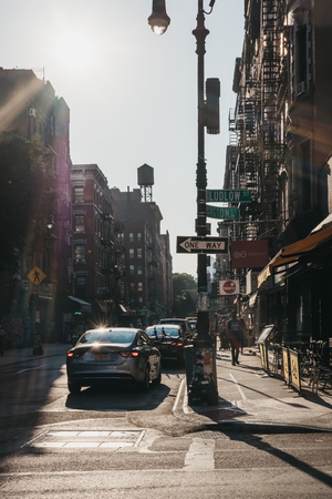 New York, USA - May 29, 2018: People walking on a street in Lower East Side, New York, USA, during golden hour.  New York is one of the most visited cities in the world.のeditorial素材