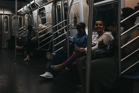 New York, USA - June 2,  2018: People inside a subway train in New York. New York City Subway is one of the world's oldest public transit systems.のeditorial素材