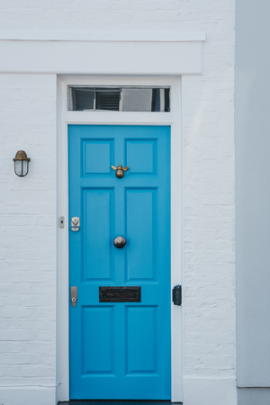 Traditional colourful bright blue door on a house in London, UK.の写真素材