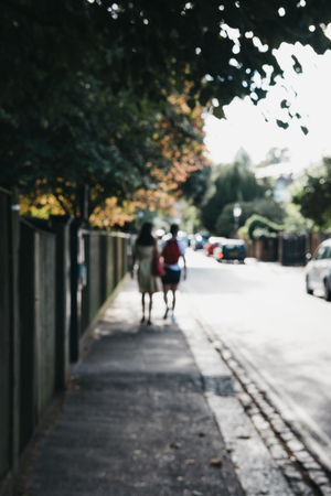 Out of focus abstract view of a couple walking on a street in London, UK.の写真素材