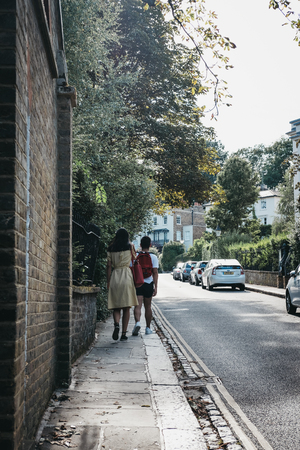 London, UK - August 1, 2018: Rear view of a couple walking on a street in Hampstead, London, an...