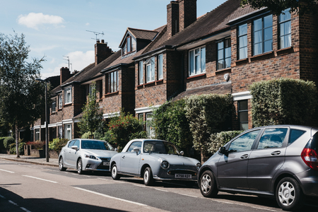London, UK - August 1, 2018: Row of typical British houses in Barnes, an affluent residential area of London famous for its village atmosphere, cars parked outside.のeditorial素材
