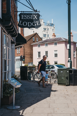London, UK - August 1, 2018: People walking past the shops in Barnes, an affluent residential area...