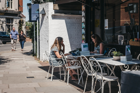 London, UK - August 1, 2018: Women sitting and chatting at an outdoor table of a cafe in Barnes, an affluent residential area of London famous for its village atmosphere.のeditorial素材