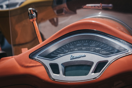 London, UK - August 1, 2018: Close up of a colourful Vespa motorbike parked by a house in Barnes, London. Vespa is a famous Italian brand of scooter manufactured by Piaggio.のeditorial素材