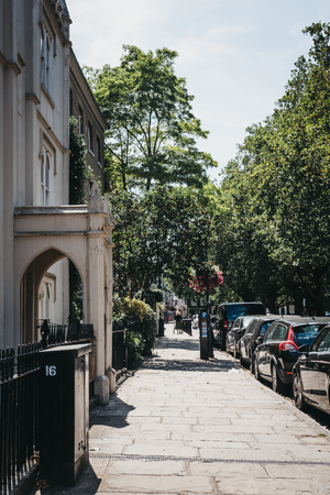 London, UK - August 1, 2018. People walking past greenery on a street in Richmond, a suburban town in south-west London famous for a large number of parks and open spaces.のeditorial素材