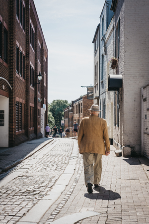 London, UK - August 1, 2018. Rear view of a senior man walking on a street in Richmond, a suburban town in south-west London famous for a large number of parks and open spaces.のeditorial素材