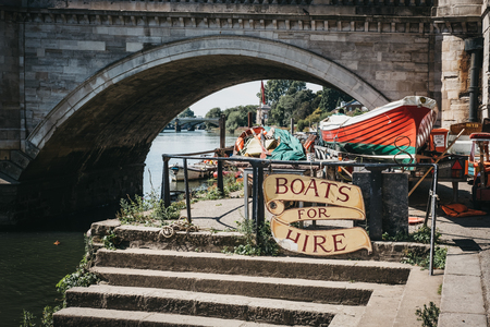 London, UK - August 1, 2018. Richmond Bridge Boat Hire sign on the River Thames riverside in Richmond, a suburban town in south-west London famous for a large number of parks and open spaces.のeditorial素材