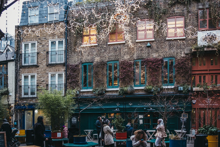 London, UK - November 21, 2018: People under the Christmas lights in Neal's Yard, Covent Garden, London. Covent Garden is a famous tourist area of London with lots of shops and restaurants.のeditorial素材