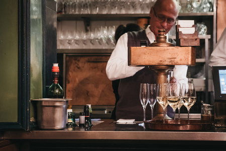 Vienna, Austria - Novermber 24, 2018: Bartender preparing drinks inside Figlmuller restaurant on...