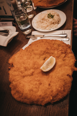Vienna, Austria - Novermber 24, 2018: Schnitzel served inside Figlmuller on Wollzeile restaurant in Vienna. Opened in 1905, it is often referred to as the âHome of the Schnitzelâ.のeditorial素材