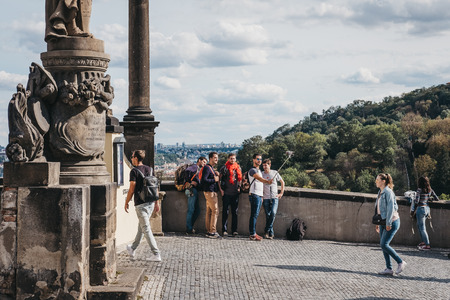 Prague, Czech Republic - August 26, 2018: Tourists taking selfies at a viewing platform near Prague Castle, a castle complex in Prague that is an official office of the President of the Czech Republicのeditorial素材