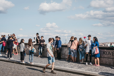 Prague, Czech Republic - August 26, 2018: People walking on a viewing platform near Prague Castle, a castle complex in Prague that is an official office of the President of the Czech Republic.のeditorial素材