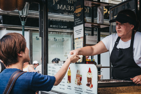 Prague, Czech Republic - August 23, 2018: Tourists buying Trdelnik, a sweet pastry that is popular amongst locals and tourists and is sold in many European countries, mostly in the Czech Republic.のeditorial素材