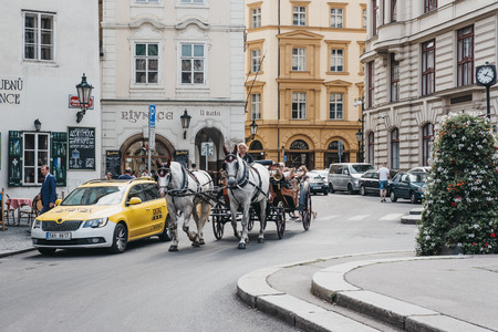 Prague, Czech Republic - August 28, 2018: Horse and carriage tour on a street in Prague. Carriage...