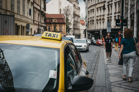 Prague, Czech Republic - August 23, 2018: Close up of a sign on yellow taxi on a street in Prague....