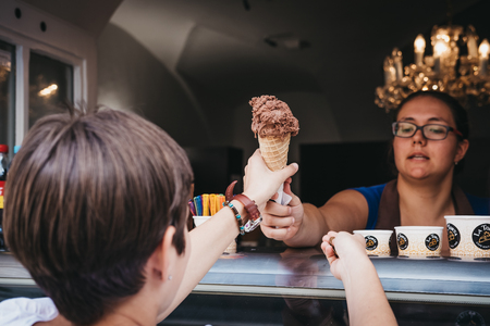 Prague, Czech Republic - August 23, 2018: Tourists buying ice-cream from a shop in the Old Town in Prague, one of the oldest and the most beautiful district in Prague, Czech Republic.のeditorial素材
