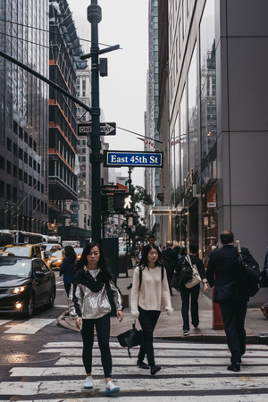 New York, USA - May 28, 2018: People crossing East 45th Street on a zebra crossing in New York, USA. New York is one of the most visited cities in the world.のeditorial素材
