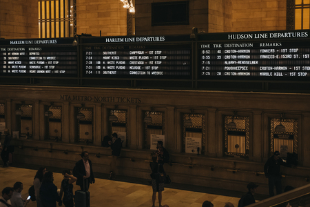 New York, USA - May 28, 2018: Train times and Harlem trains departure board inside Grand Central Terminal, a world-famous landmark and transportation hub in Midtown Manhattan, New York.のeditorial素材