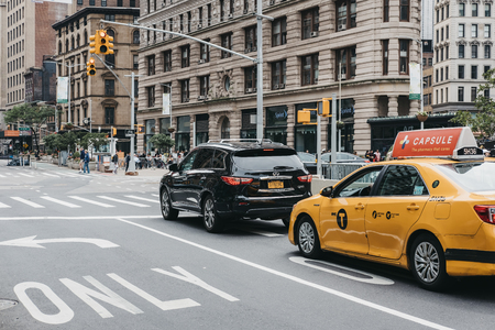 New York, USA - May 30, 2018: Car and yellow taxi waiting on traffic light on street in Manhattan New York, USA. New York is the third most traffic congested city in the world.のeditorial素材