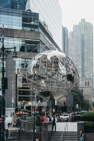 New York, USA - June 01, 2018: People near Globe sculpture by Kim Brandell at Columbus Circle, New York. The circle is the point from which official highway distances from New York City are measuredのeditorial素材