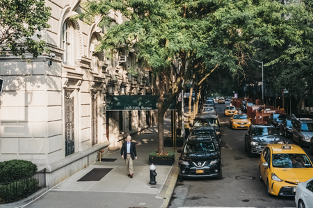 New York, USA - May 30, 2018: Well dressed man walking on Fifth Avenue in New York, USA. New York is...