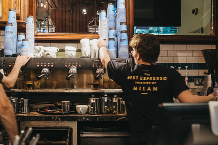London, UK - January 26, 2019: Staff working behind the counter in Cafe Nero, a British European style coffee house brand headquartered in London, England, UK.のeditorial素材