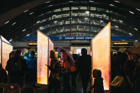 London, UK - January 26, 2019: People walking inside Winter Lights festival by the station in Canary Wharf. Canary Wharf is a busy financial area of London that often host events.のeditorial素材