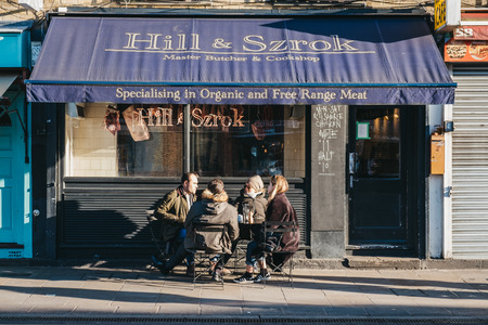 London, UK - February 03, 2019: People sitting at an outdoor table of a cafe on Broadway Market, a shopping street in the heart of Hackney, East London, UK.のeditorial素材