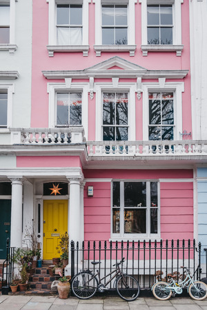 London, UK - February 16, 2019: Bicycles by pastel pink coloured terraced house in Primrose Hill. Primrose Hill is one of the most expensive residential areas in London.のeditorial素材