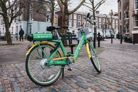 London, UK - February 16, 2019: Dockless Lime E electric bike on a street in Primrose Hill, London. Bike sharing company Lime, by Californian transportation company, arrived to London in December 2018のeditorial素材