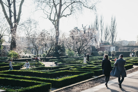 London, UK - February 23, 2019: People walking inside Holland Park, London, on a sunny spring day. Holland park is the largest park in Kensington and Chelsea borough with 22.5 hectares of gardens.のeditorial素材
