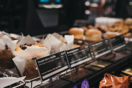 London, UK - February 23, 2019: Muffins and sweets on sale inside Pret a Manger, a popular international sandwich shop chain that is based in UK and has approximately 500 shops in nine countries.のeditorial素材