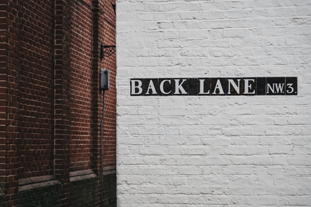 Street name sign on a side of the building on Back Lane, Hampstead, London, UK.のeditorial素材