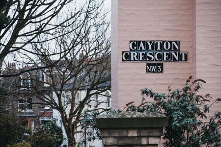 London, UK - March 2, 2019: Street name sign on a pastel pink house on Gayton Crescent, Hampstead, London. Hampstead is an affluent residential area favoured by academics, artists and media figures.のeditorial素材