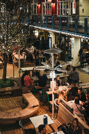 London, UK - March 6, 2019: People sitting at the outdoor tables of Kingly Court, a three-storey alfresco food and dining courtyard in the heart of Londonâs West End.のeditorial素材