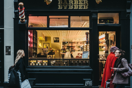 London, UK - December 18, 2018: People walking past Baba House barber shop in Covent Garden, London, UK. Covent Garden is a famous tourist area in London with lots of shops and restaurants.のeditorial素材